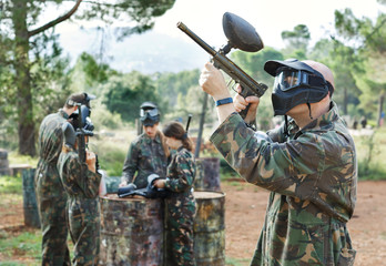 Fototapeta premium Paintball player in camouflage with gun