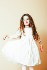 little cute girl with long curly hair posing cheerful on white background, lifestyle people concept