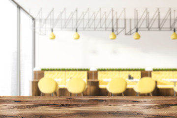 Interior of white cafe with yellow sofas blur