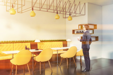 Man in suit in modern pub interior