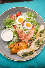 Chicken ceasar salad. Chicken, pancetta, eggs, tomatoes with garlic bread with caesar sauce. 