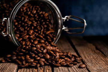 spilled coffee beans from a glass jar