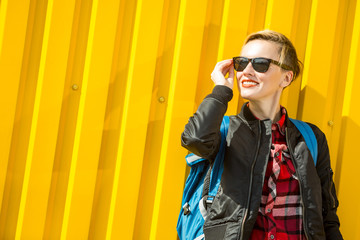Pretty smiling blonde girl walking on the street