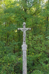 Crucifix in a forest near Paris in France, Europe