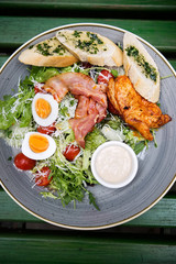 Chicken ceasar salad. Chicken, pancetta, eggs, tomatoes with garlic bread with caesar sauce. 