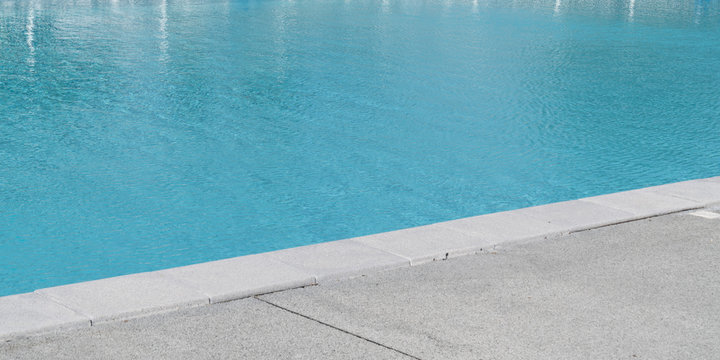 Closeup photo of pool edge blue water