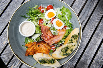 Chicken ceasar salad. Chicken, pancetta, eggs, tomatoes with garlic bread with caesar sauce. 