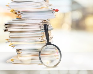 Stack of Documents / Files with Magnifying Glass