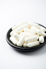 Fototapeta na wymiar Creatine capsules. Bodybuilding food supplement on white background. 