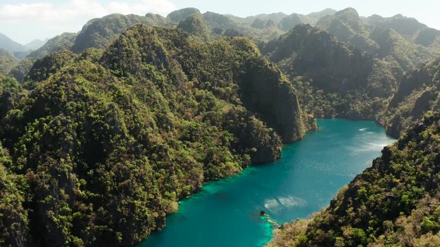Aerial drone Kayangan lake with blue water on tropical island Coron. Lake in the mountains covered with tropical forest. Palawan, Philippines