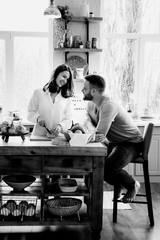 Romantic young couple cooking together in the kitchen,having a great time together.