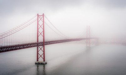 Big red bridge in Lisbon. Misty morning.