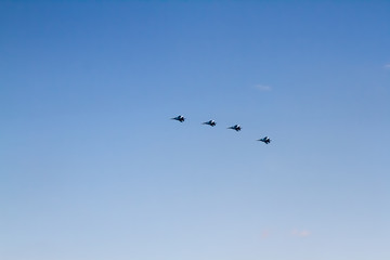 Military aircraft against the blue sky. Sunny day. Aircraft. Fighters