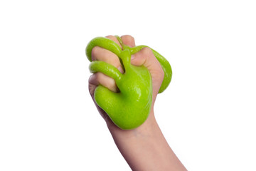 child's hand holds a green slime, isolated on white