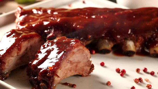 closeup dolly shot of caramelized marinated spare ribs with smoke