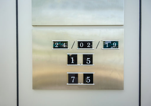 Metal information calendar board with plastic adjustable numbers.