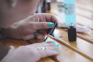 woman self nail painting at home