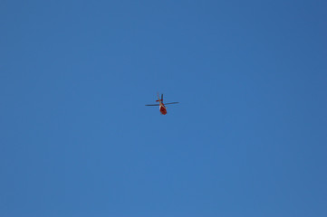 Helicopter high in sky