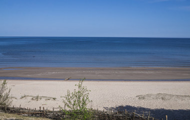 Beautiful view of the Gulf of Riga in the early spring. The sea is calm.