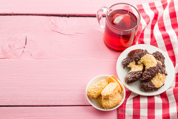 Sweet biscuits dessert and red fruity tea.