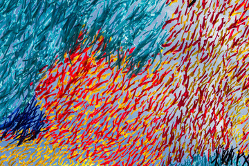 Lots of colorful ribbons fluttering and waving in the blue sky, red, yellow, blue texture decoration of public park. Decor and beauty. Multicolored texture decoration made by ribbons.