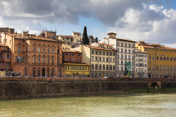 Amazing residential buildings on the embankment of river Arno in Florence, Italy. Different old facades, historical buildings, Italian Firenze architecture and shutter windows. Bright sunny day.