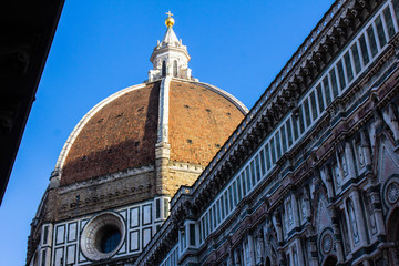 Fototapeta premium The dome of Florence Cathedral, Cattedrale di Santa Maria del Fiore. The main cathedral of Florence roof with blue sky above it. Italy, architecture, awesome church.