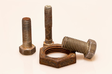 Three old bolts and a rusty nut