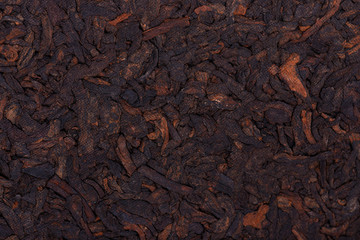 Chinese tea Shou Puer. Pressed fermented Pu-erh tea. Macro close up. Aromatic black puer tea. Healthy drink. Texture.