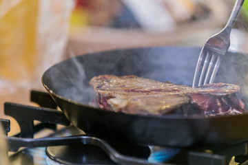 Grilling steak on grill pan. Beefsteak cooking on a kitchen. Fresh, delicious meat