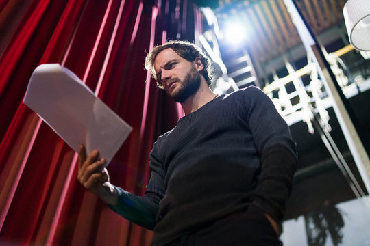 Actor rehearsing with script