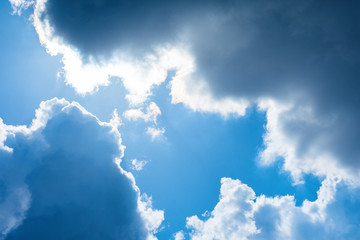 Beautiful blue sky and clouds. Beams of light. The natural background. Texture.