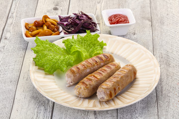 Grilled sausages served mushrooms and cabbage