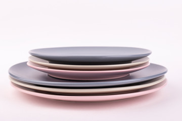 Set of different plates of gray, pink and olive colors, isolate