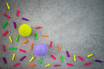 Colorful balloons and rubber balls on concrete background