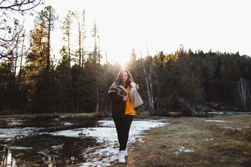 Cheerful young woman on pond in forest