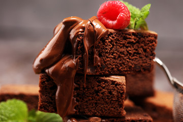chocolate brownie cake dessert with raspberry and spices on a rustic background