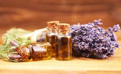 essential lavender oil in a glass bottle on a background of fresh flowers