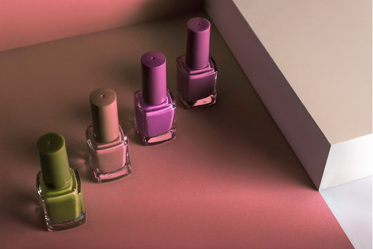 Multi-colored nail polish on pastel colors geometric pattern background