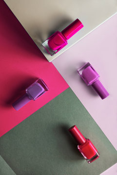 Multi-colored nail polish on pastel colors geometric pattern background