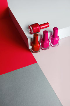 Multi-colored nail polish on pastel colors geometric pattern background
