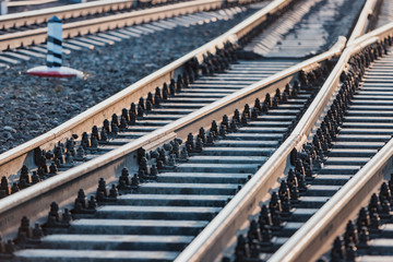 Fototapeta premium View of the rails, concrete sleepers and mound of crushed stone. The railroad tracks.