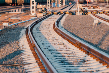 View of the rails, concrete sleepers and mound of crushed stone. The railroad tracks.