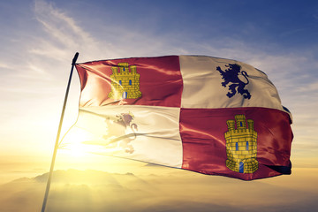 Castile and Leon of Spain flag waving on the top sunrise mist fog