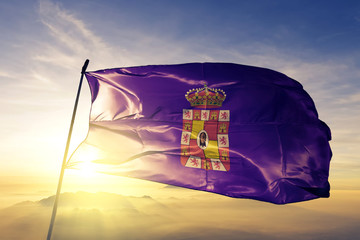 Jaen province of Spain flag waving on the top sunrise mist fog
