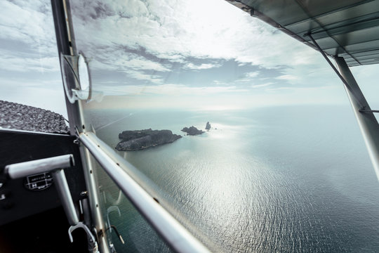 Aerial view on some islands from the inside of a small plane
