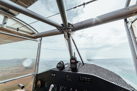 Aerial view from inside the cockpit of a small plane