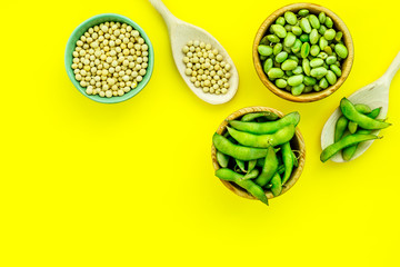 Green soybeans background on yellow desk top view mockup
