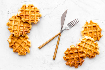 homemade Belgian waffles on served table on marble background top view