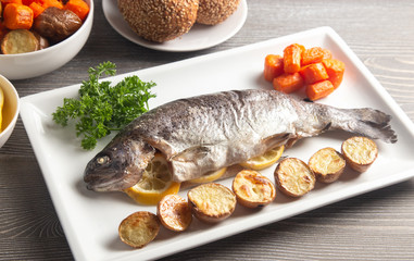 Whole Baked Rainbow Trout on a Table Set for Dinner